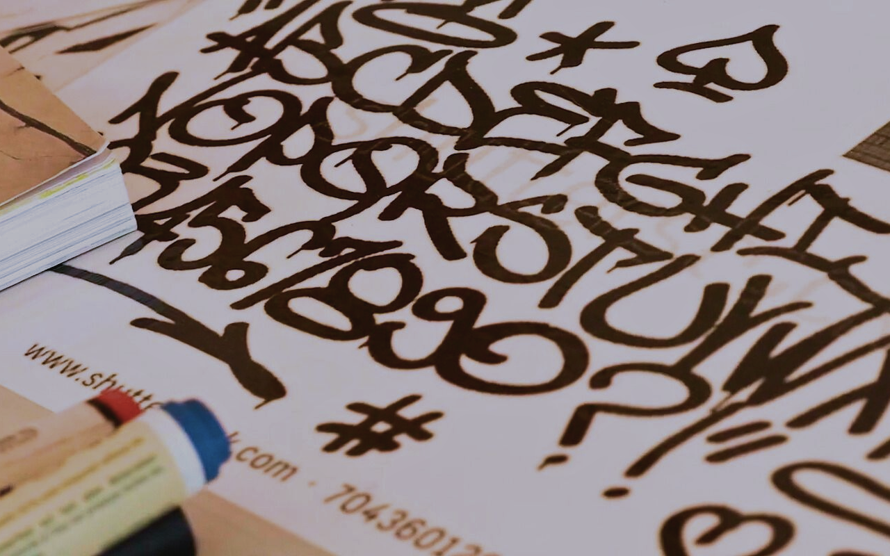 Teenager creating buttons in a workshop