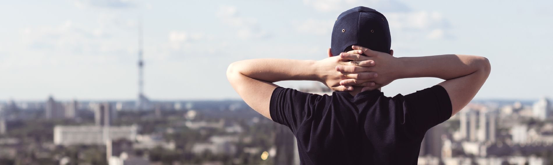 Young person looking at the skyline of a city