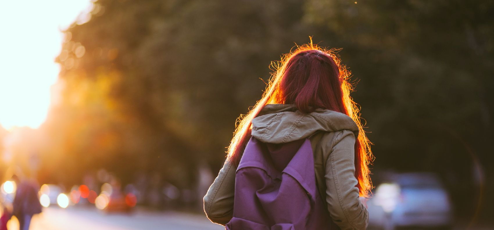 Rear view of a young woman with a backpack